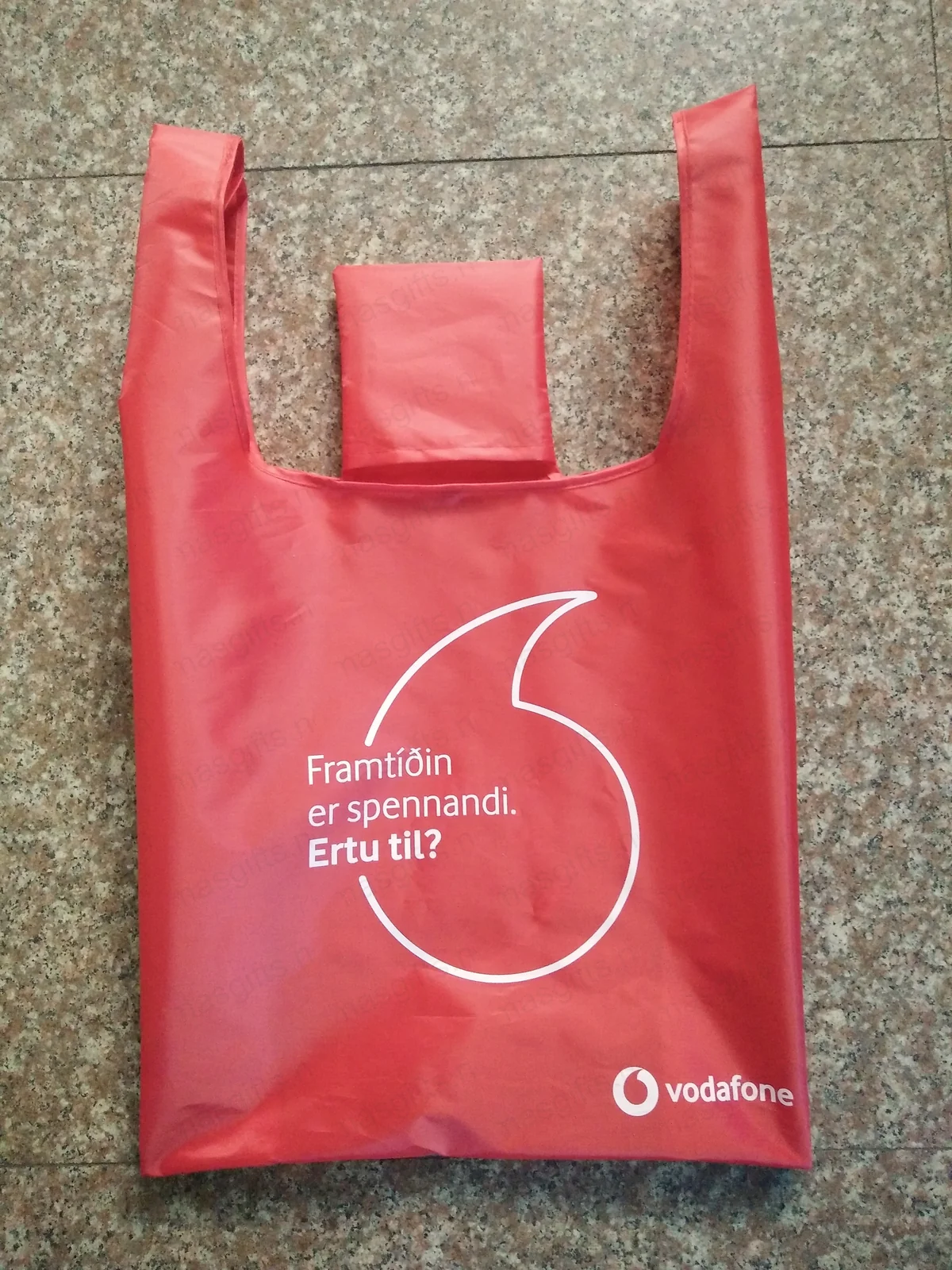 Red Vodafone grocery bag with Icelandic tagline Framtíðin er spennandi