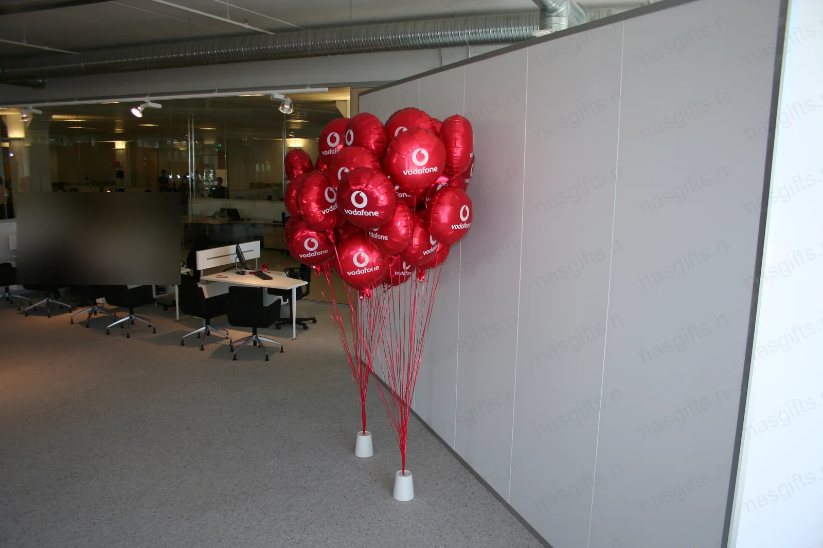 Vodafone red balloons displayed in an office